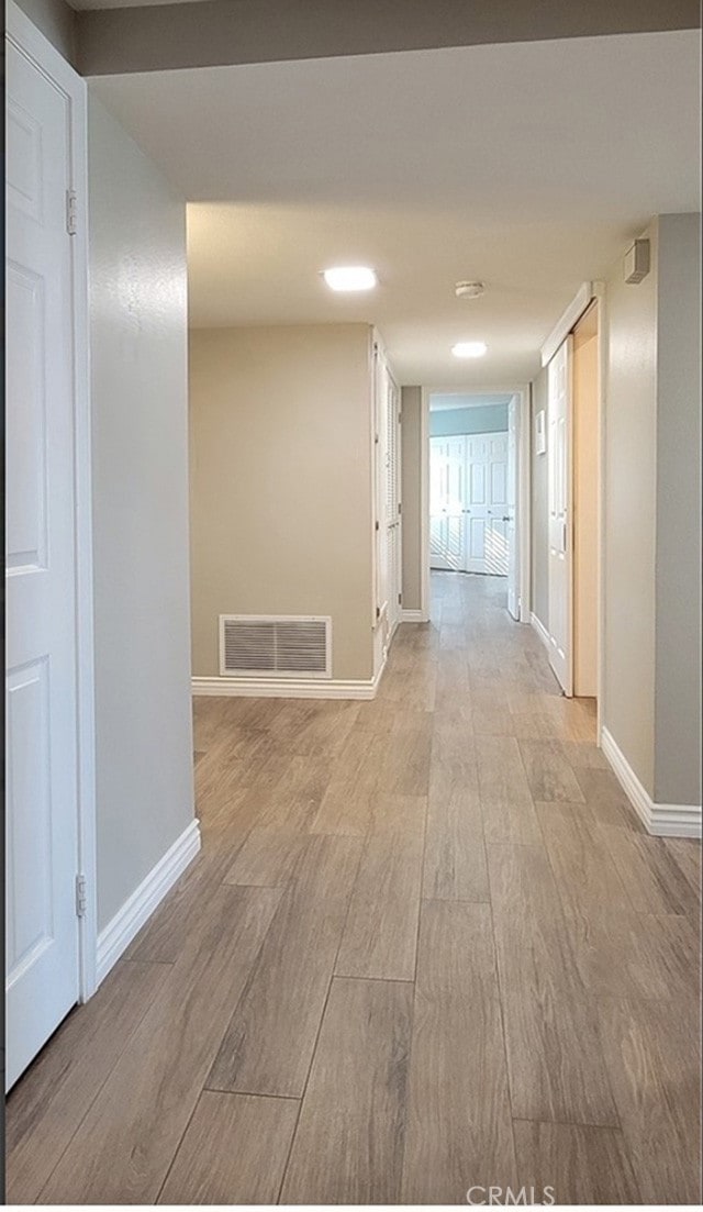 corridor featuring light wood-type flooring