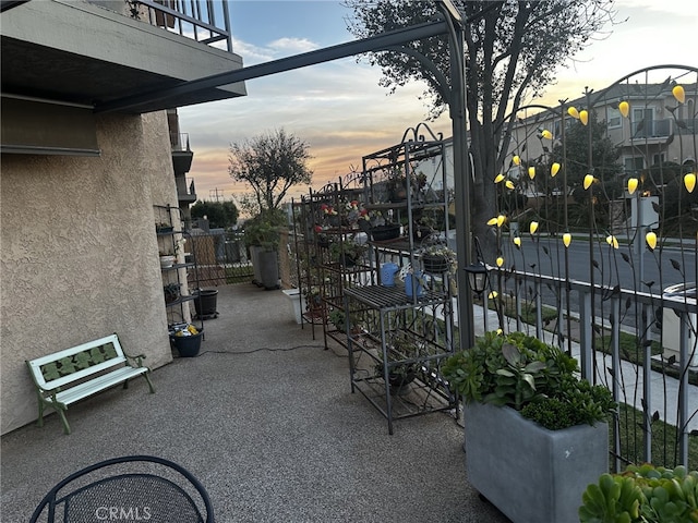 patio terrace at dusk with a balcony