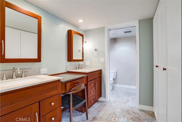 bathroom with vanity and toilet