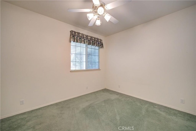 unfurnished room featuring ceiling fan and carpet flooring