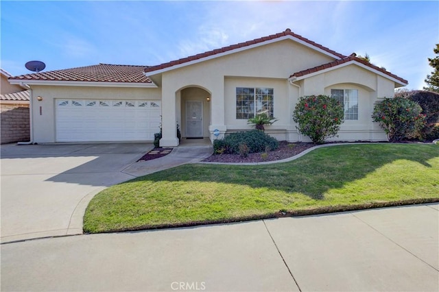 mediterranean / spanish home featuring a front yard and a garage