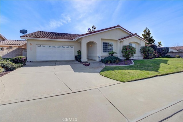 mediterranean / spanish house with a front yard and a garage