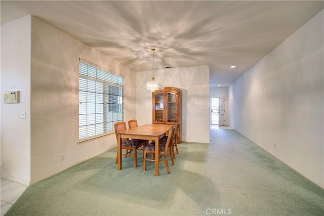 dining space featuring light carpet