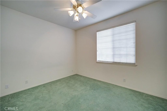 empty room with ceiling fan and light colored carpet