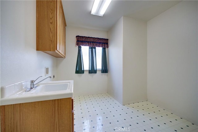 clothes washing area featuring sink, cabinets, and hookup for a washing machine