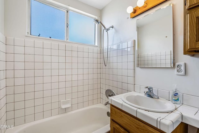 bathroom with vanity and tiled shower / bath combo