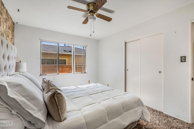 carpeted bedroom featuring ceiling fan and a closet