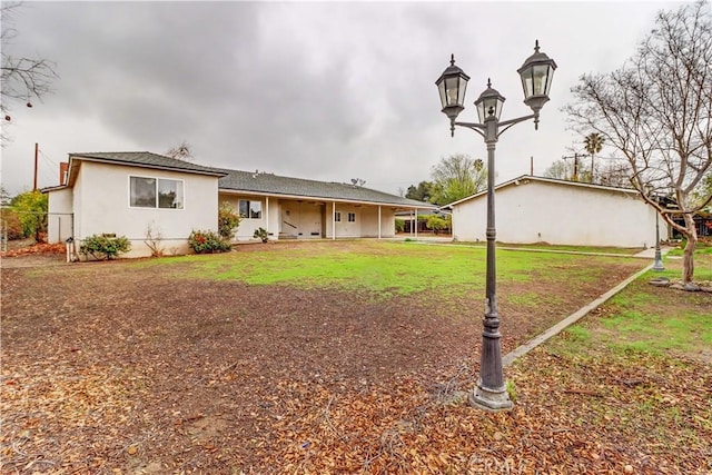 rear view of property featuring a yard