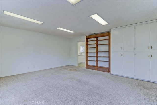 unfurnished room featuring light colored carpet