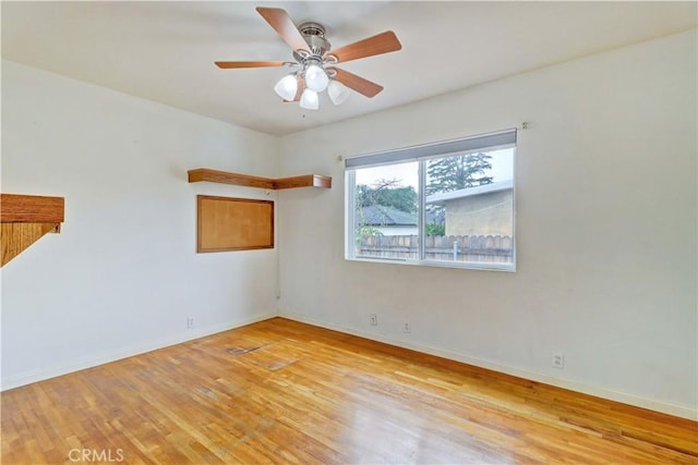 empty room featuring ceiling fan and light wood-type flooring