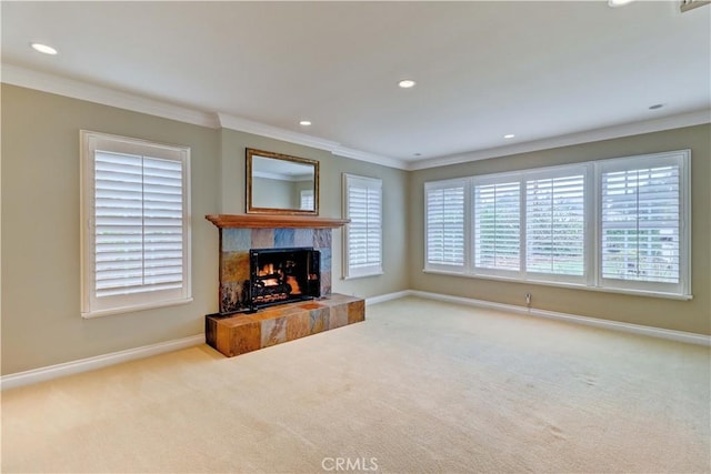 living room with light carpet, crown molding, and a tile fireplace