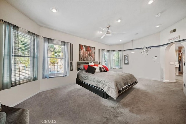 bedroom with multiple windows and carpet