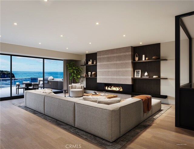 23502 Seaward Isle, Dana Point, CA 92629 - living room featuring wood finished floors, recessed lighting, a large fireplace, and a water view