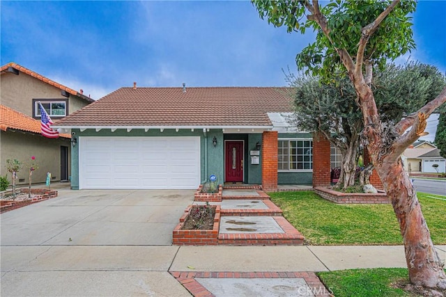 view of front of house featuring a garage and a front lawn