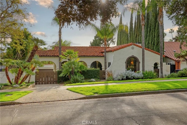 mediterranean / spanish house with a front lawn