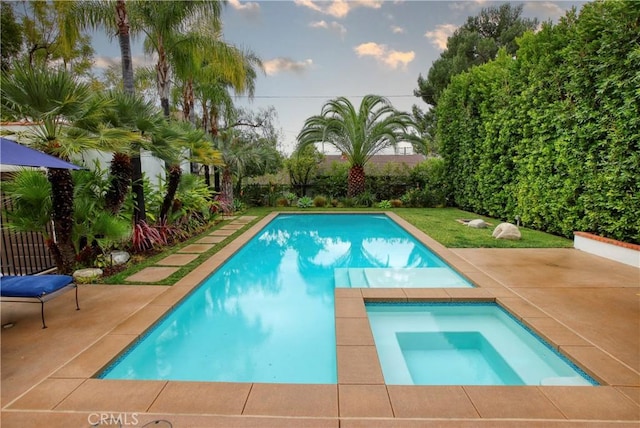 view of swimming pool featuring an in ground hot tub and a patio