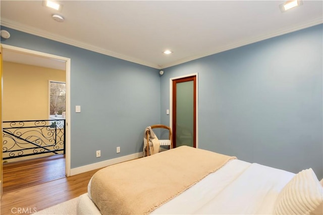 bedroom featuring wood-type flooring and ornamental molding