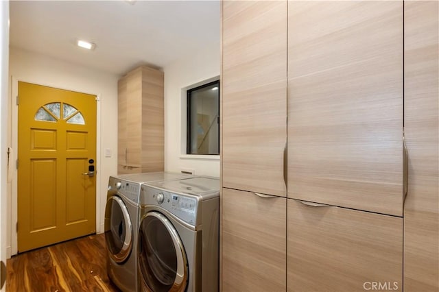 laundry area featuring dark hardwood / wood-style flooring and washing machine and clothes dryer