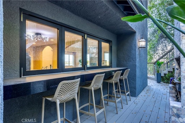 wooden deck featuring an outdoor bar