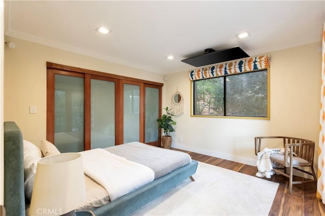 bedroom featuring crown molding and dark hardwood / wood-style flooring