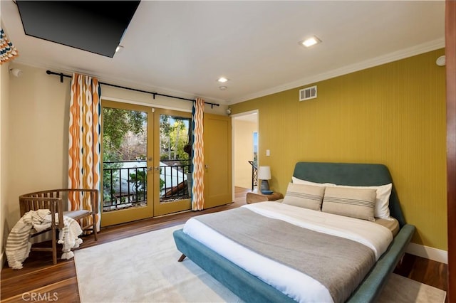 bedroom with hardwood / wood-style flooring, ornamental molding, access to exterior, and french doors