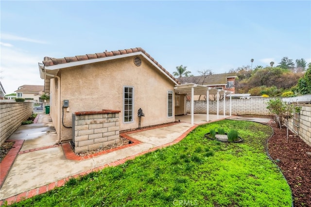 rear view of property with a patio and a pergola