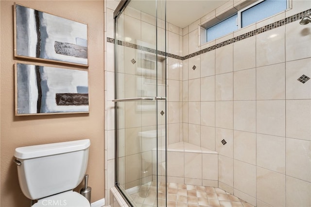 bathroom featuring toilet and an enclosed shower