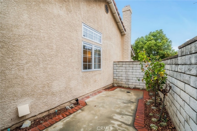 view of side of property featuring a patio area