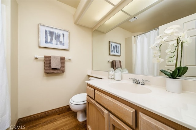 bathroom featuring vanity, hardwood / wood-style floors, and toilet