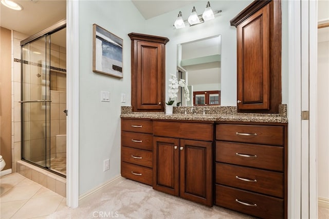 bathroom featuring vanity and a shower with shower door