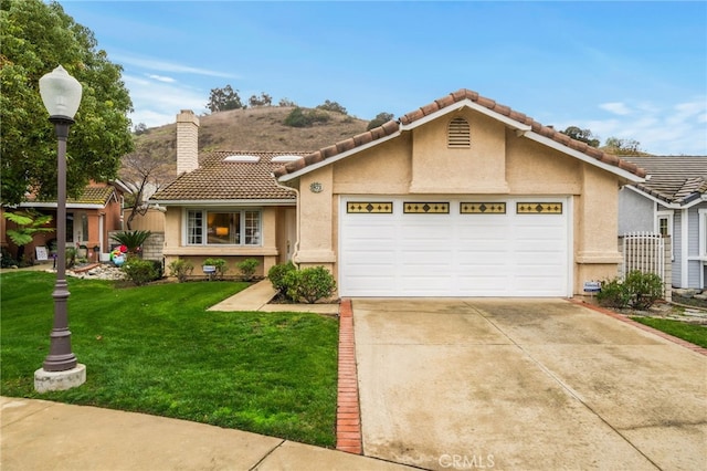 view of front of property with a garage and a front lawn