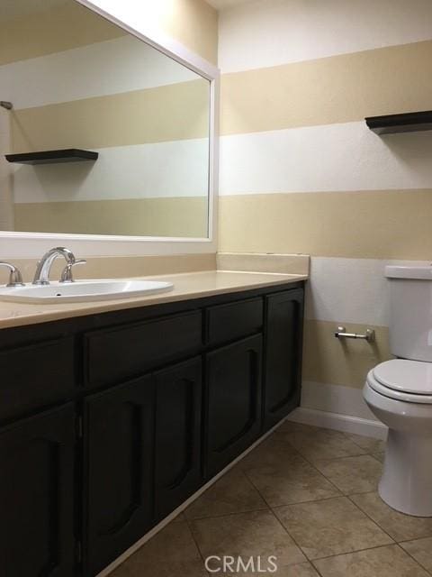 bathroom featuring vanity, toilet, and tile patterned flooring