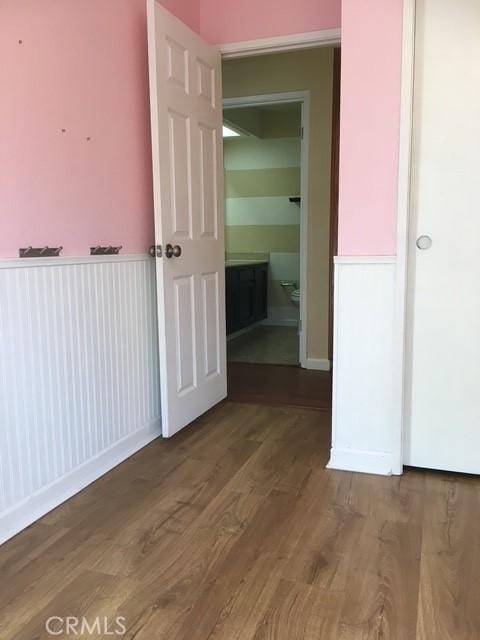 corridor with hardwood / wood-style floors