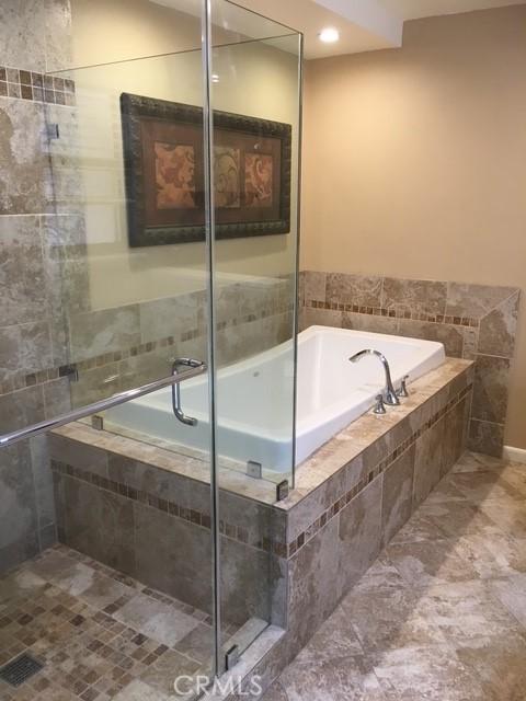 bathroom with tiled tub