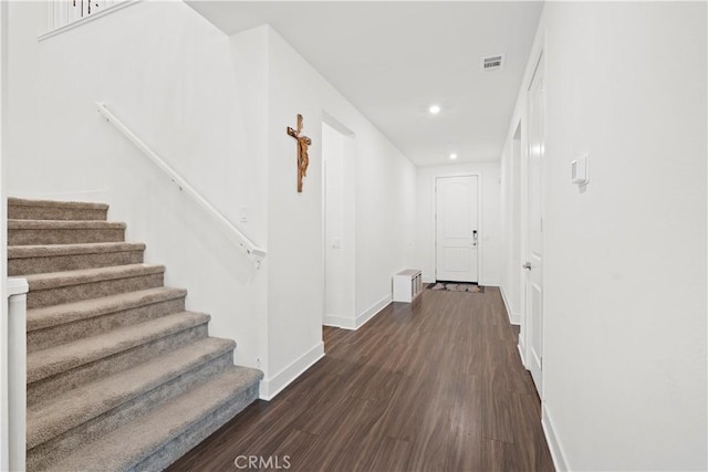 hall featuring visible vents, baseboards, stairs, recessed lighting, and dark wood-style floors