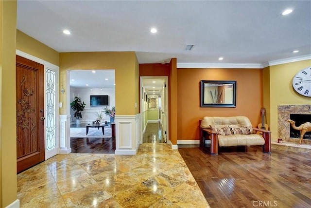 foyer featuring hardwood / wood-style floors and ornamental molding