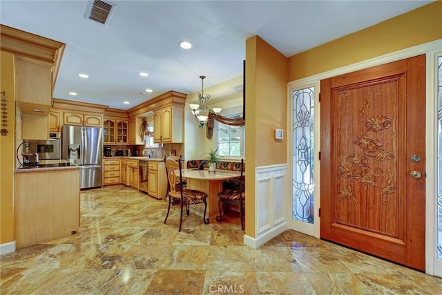 entrance foyer featuring an inviting chandelier and sink