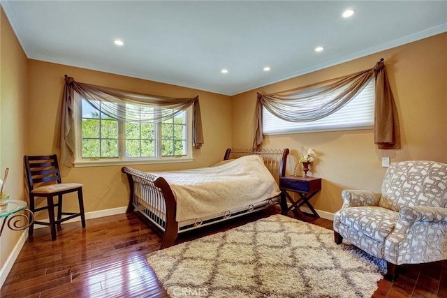 bedroom with dark hardwood / wood-style flooring and crown molding