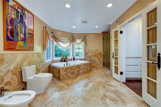 bathroom featuring a bidet, crown molding, separate shower and tub, french doors, and toilet