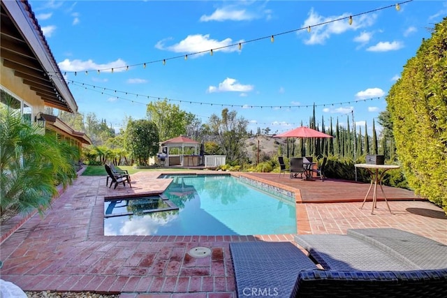 view of swimming pool with a gazebo, a patio area, and a deck