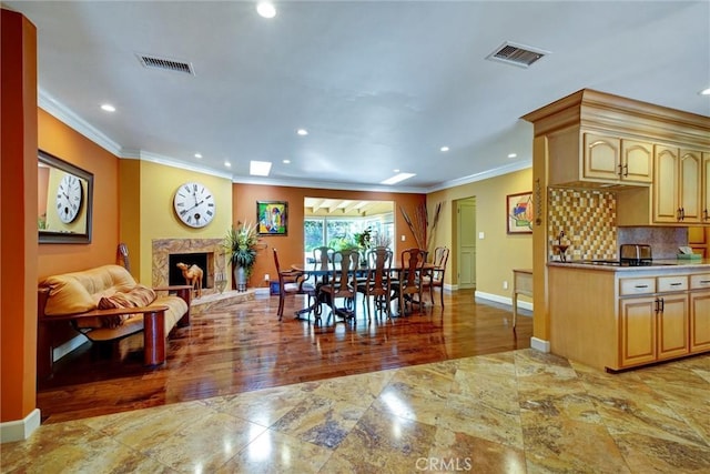 dining room with crown molding, a high end fireplace, and dark hardwood / wood-style floors