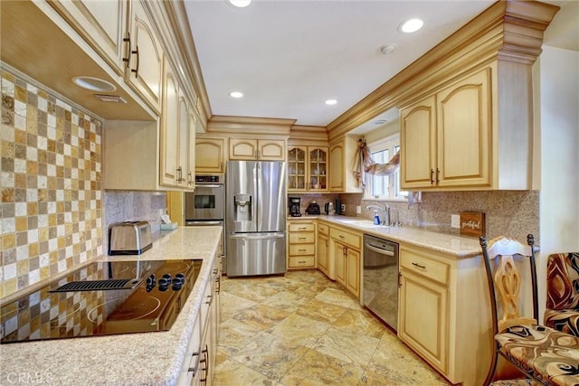 kitchen with stainless steel appliances, tasteful backsplash, sink, and light brown cabinets