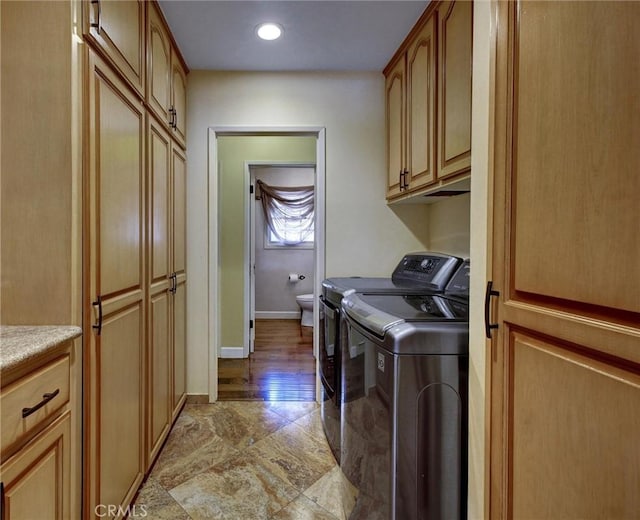 laundry area with cabinets and separate washer and dryer