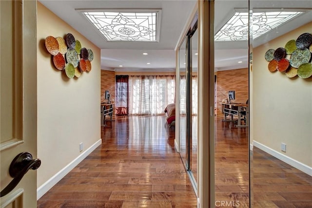 corridor with hardwood / wood-style floors