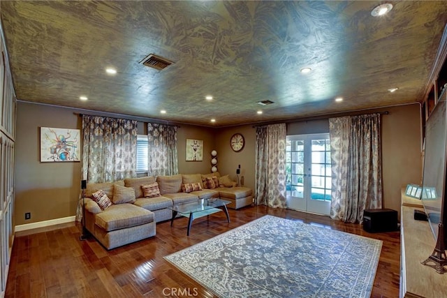 living room with wood-type flooring, a healthy amount of sunlight, ornamental molding, and french doors