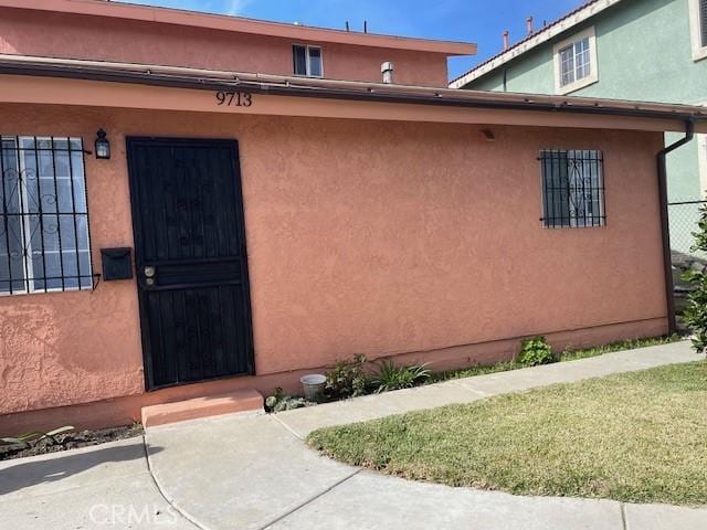 doorway to property with a yard