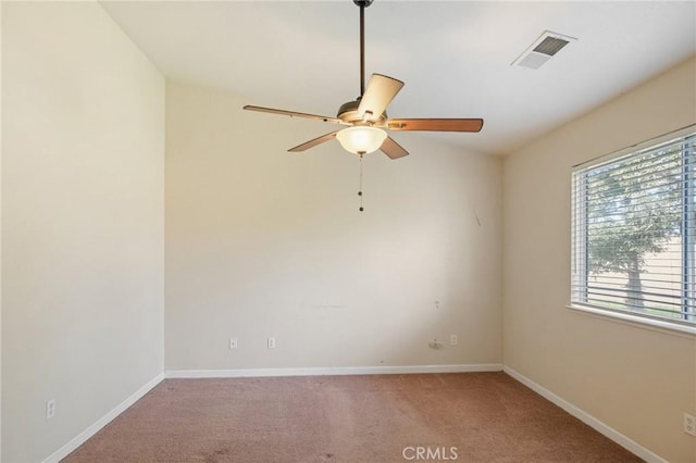 spare room featuring ceiling fan and light carpet