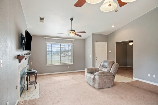 sitting room featuring ceiling fan, vaulted ceiling, and light carpet