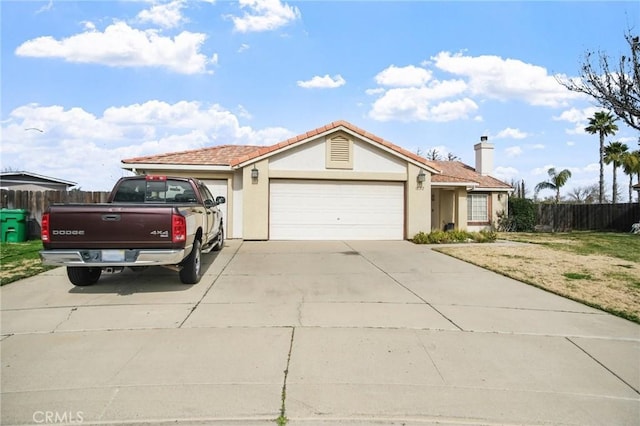 ranch-style house featuring stucco siding, concrete driveway, fence, a garage, and a front lawn