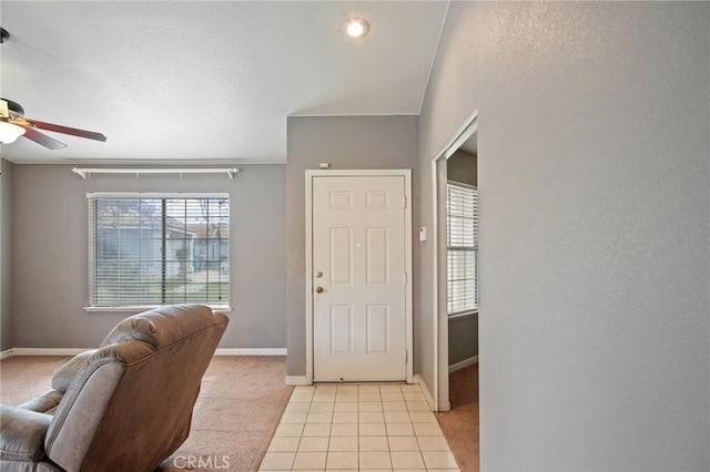 entryway featuring light tile patterned floors and ceiling fan